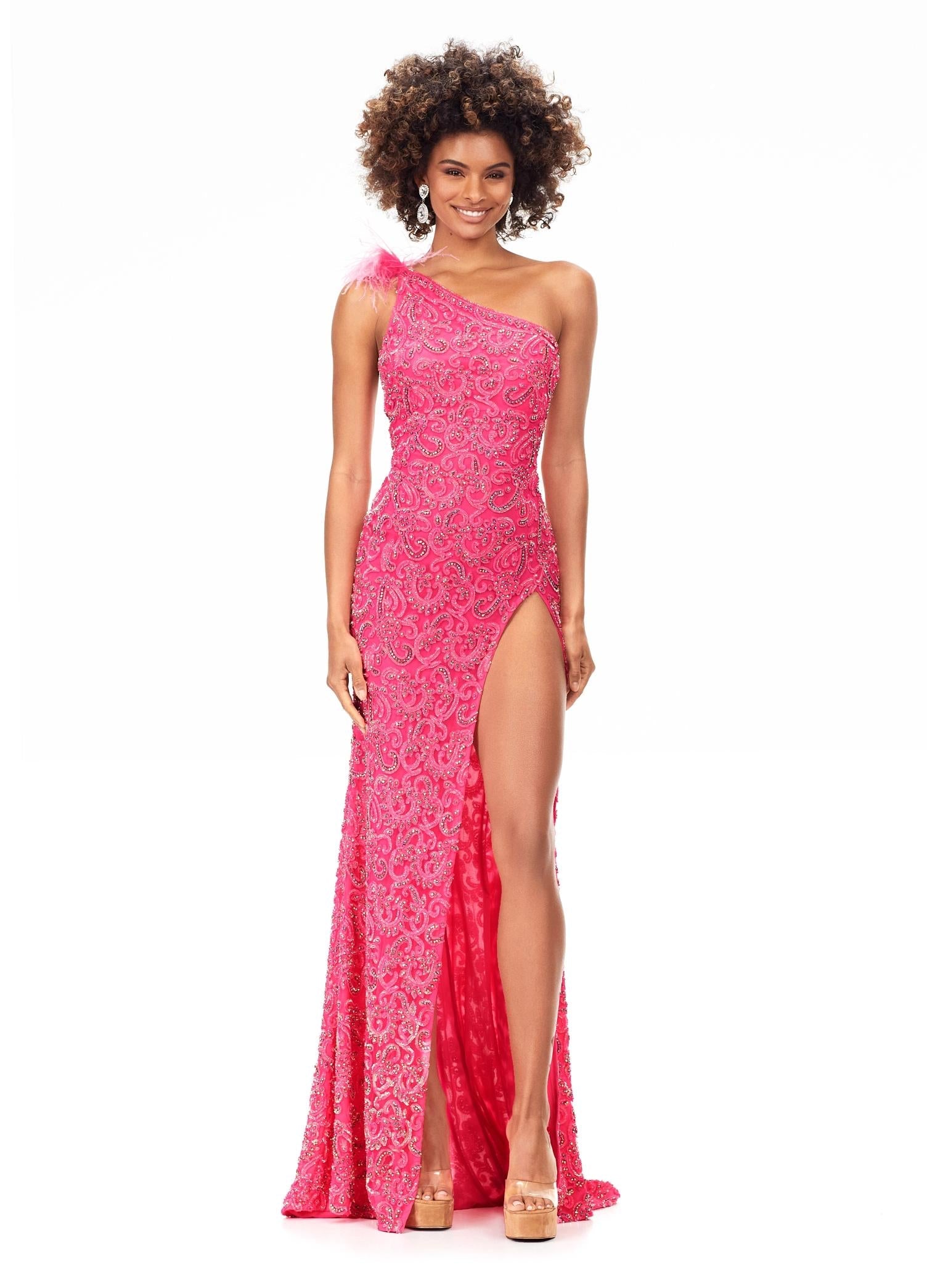 Pink ASHLEYlauren 11277 one shoulder gown featuring intricate sequin and crystal beading, feather-accented neckline, left leg slit, and strappy open back.