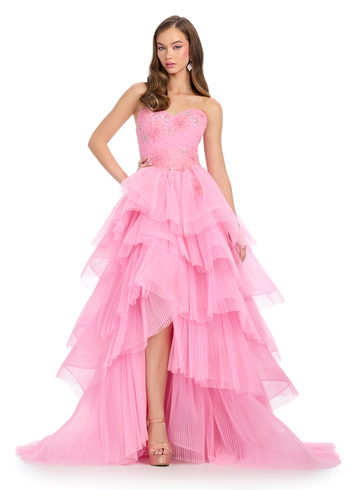 Enchanting tiered tulle gown featuring a strapless sweetheart neckline, delicate floral embellishments, and shimmering crystal and beaded accents that cascade down the A-line skirt for a dreamy, ethereal look. Perfect for special occasions.