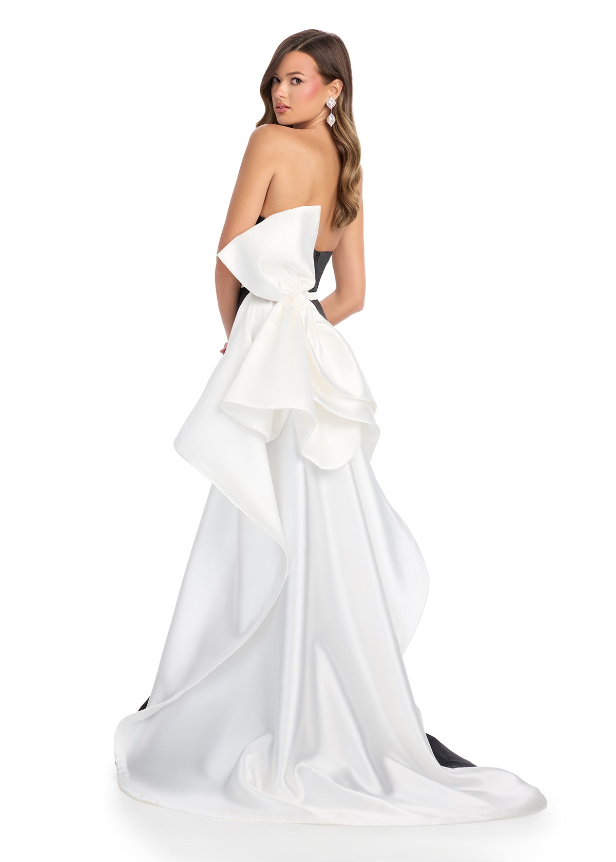 Back -  Elegant strapless mikado gown featuring a sleek belt, a left leg slit, and a statement back bow that cascades down onto the sweep train for a dramatic and sophisticated finish. Perfect for special occasions.