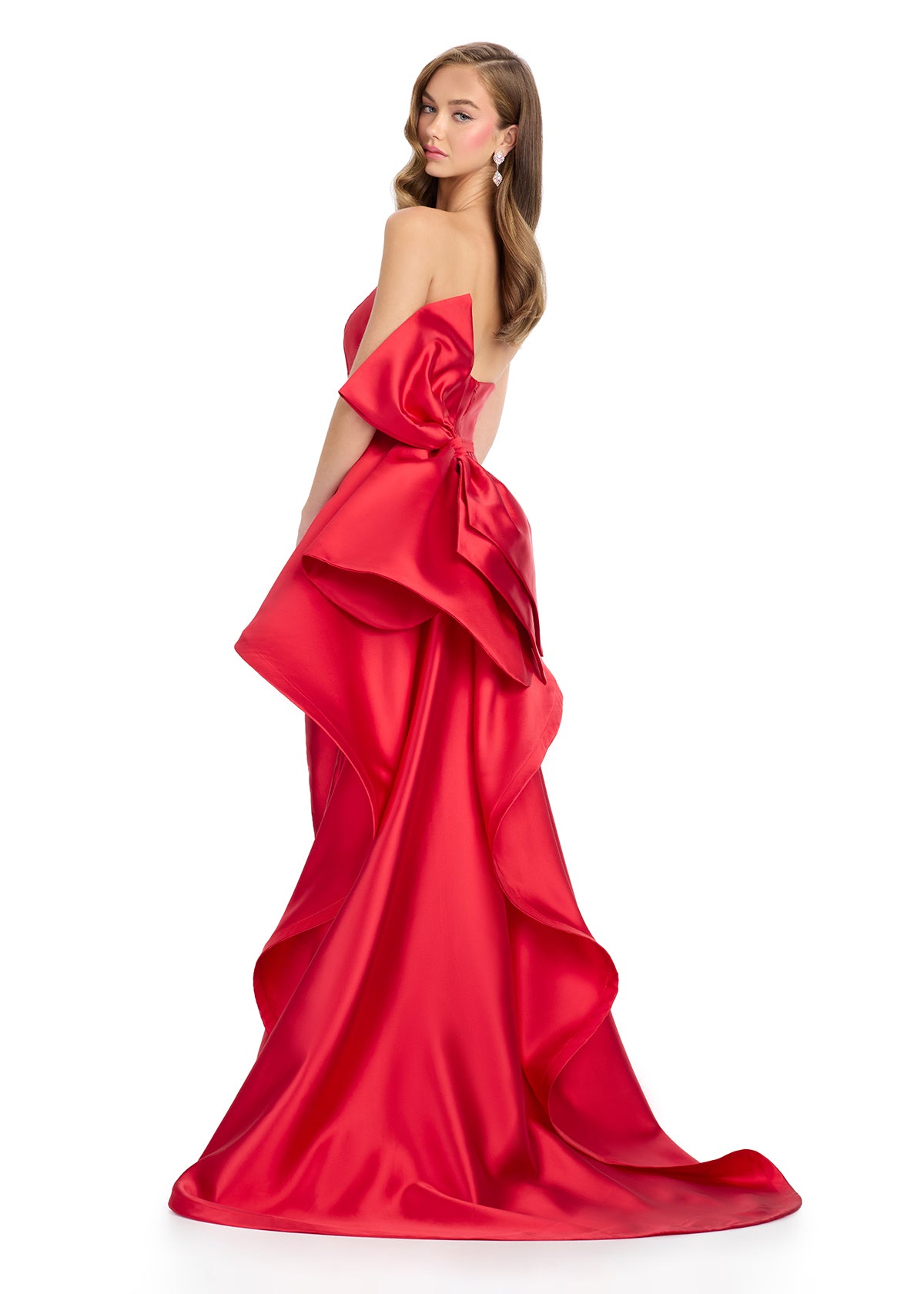 Back -  Elegant strapless mikado gown featuring a sleek belt, a left leg slit, and a statement back bow that cascades down onto the sweep train for a dramatic and sophisticated finish. Perfect for special occasions.