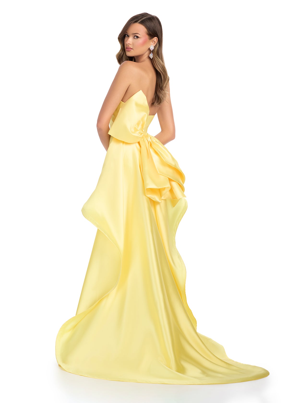 Back -  Elegant strapless mikado gown featuring a sleek belt, a left leg slit, and a statement back bow that cascades down onto the sweep train for a dramatic and sophisticated finish. Perfect for special occasions.