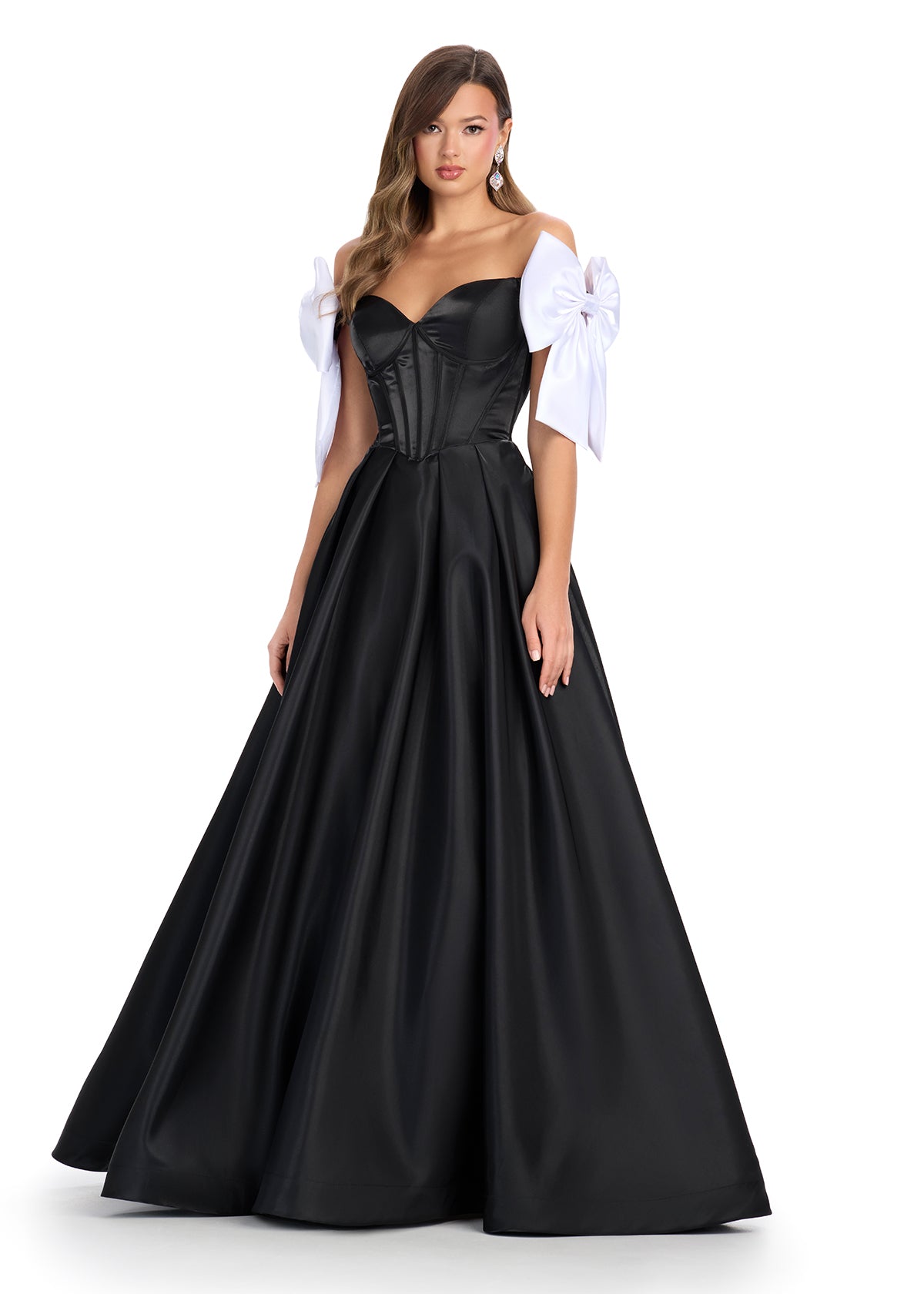 Regal satin ball gown featuring a structured corset bustier, a flattering sweetheart neckline, and elegant off-the-shoulder bow straps. Finished with a voluminous skirt for a timeless princess look. Perfect for special occasions.