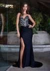 Sparkling strapless gown featuring a structured bustier adorned with press-on stones in an animal print-inspired pattern. Complete with a wrap skirt, right leg slit, and sweep train for a fierce and glamorous look. Perfect for special occasions.