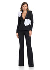 Powerfully chic two-piece jumpsuit featuring a deep V-neck blazer adorned with statement 3D floral details and sleek flare pants for the perfect blend of sophistication and fun. Ideal for making a bold entrance.