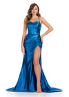 Sleek metallic jersey gown featuring delicate spaghetti straps, a lace-up back, a ruched wrap skirt, and a left leg slit for a shimmering, figure-flattering look. Perfect for any special event.