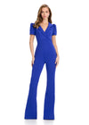 Chic scuba jumpsuit featuring a V-neckline with lapel detailing, slight puff sleeves, and flare pant legs for a stylish and sophisticated look. Perfect for any fashion-forward occasion.