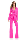 Powerfully chic two-piece scuba jumpsuit featuring a classic blazer-style jacket with a statement bow detail and fit-and-flare pants for the ultimate boss babe look. Perfect for bold and stylish occasions.