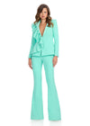 Statement two-piece jersey jumpsuit featuring a ruffle-adorned V-neckline and sleek flare pants for a bold and sophisticated look. Perfect for making an entrance at any event.