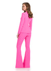 Back - Statement two-piece jersey jumpsuit featuring a ruffle-adorned V-neckline and sleek flare pants for a bold and sophisticated look. Perfect for making an entrance at any event.