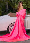Statement-making off-shoulder cape featuring an oversized bow and flowing overskirt. The perfect accessory to elevate your prom or pageant look with elegance and drama.