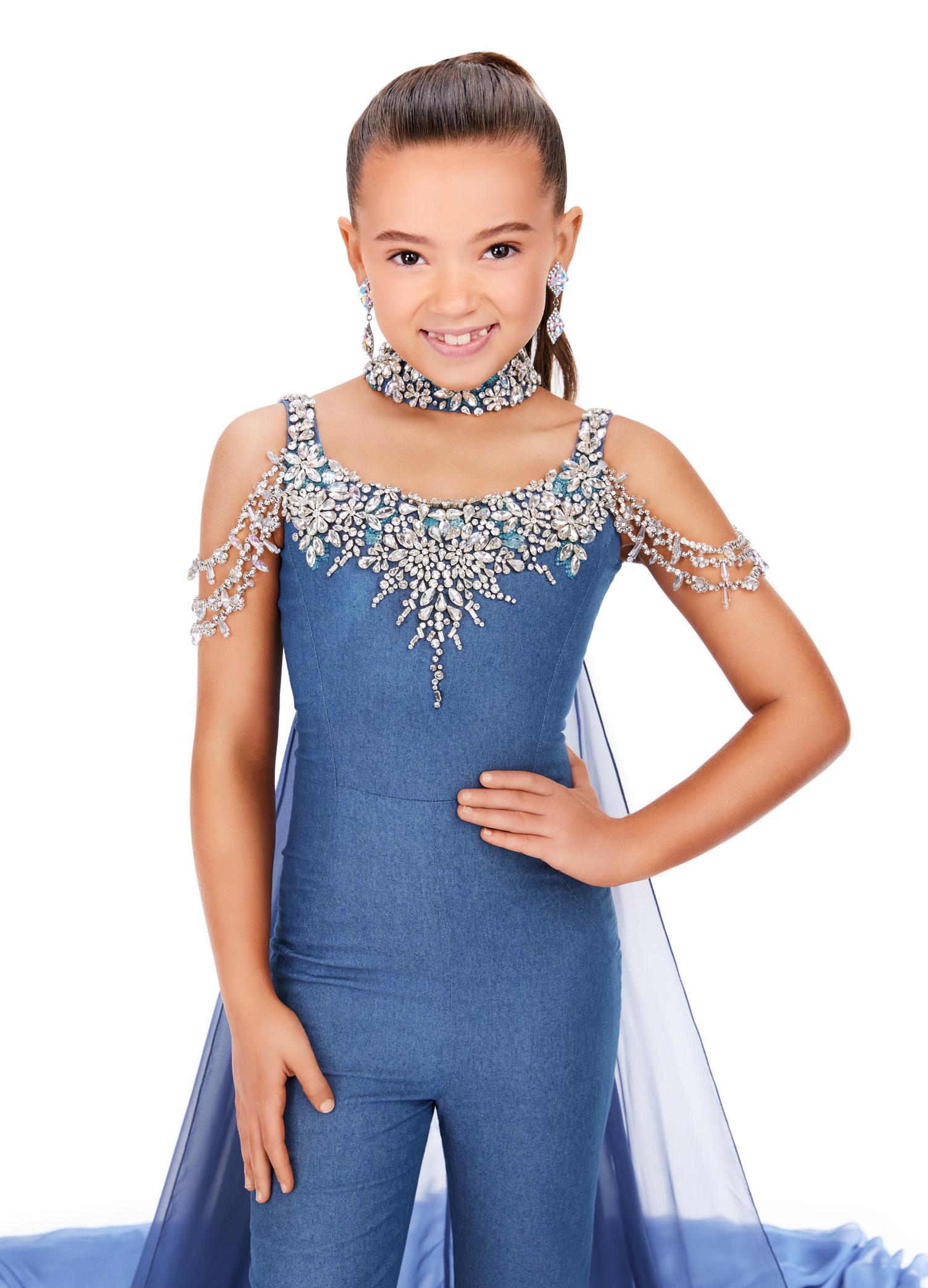 ASHLEYlauren 8267 fun kids denim jumpsuit featuring a crystal-encrusted neckline, off-shoulder draped straps, a crystal neck choker, and an attached chiffon cape for a bold and stylish statement look.