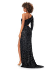 Back. Black ASHLEYlauren 11340 sequin one shoulder gown featuring a single sleeve, shark bite cut-out, wrap skirt, and left leg slit for a striking and glamorous look.