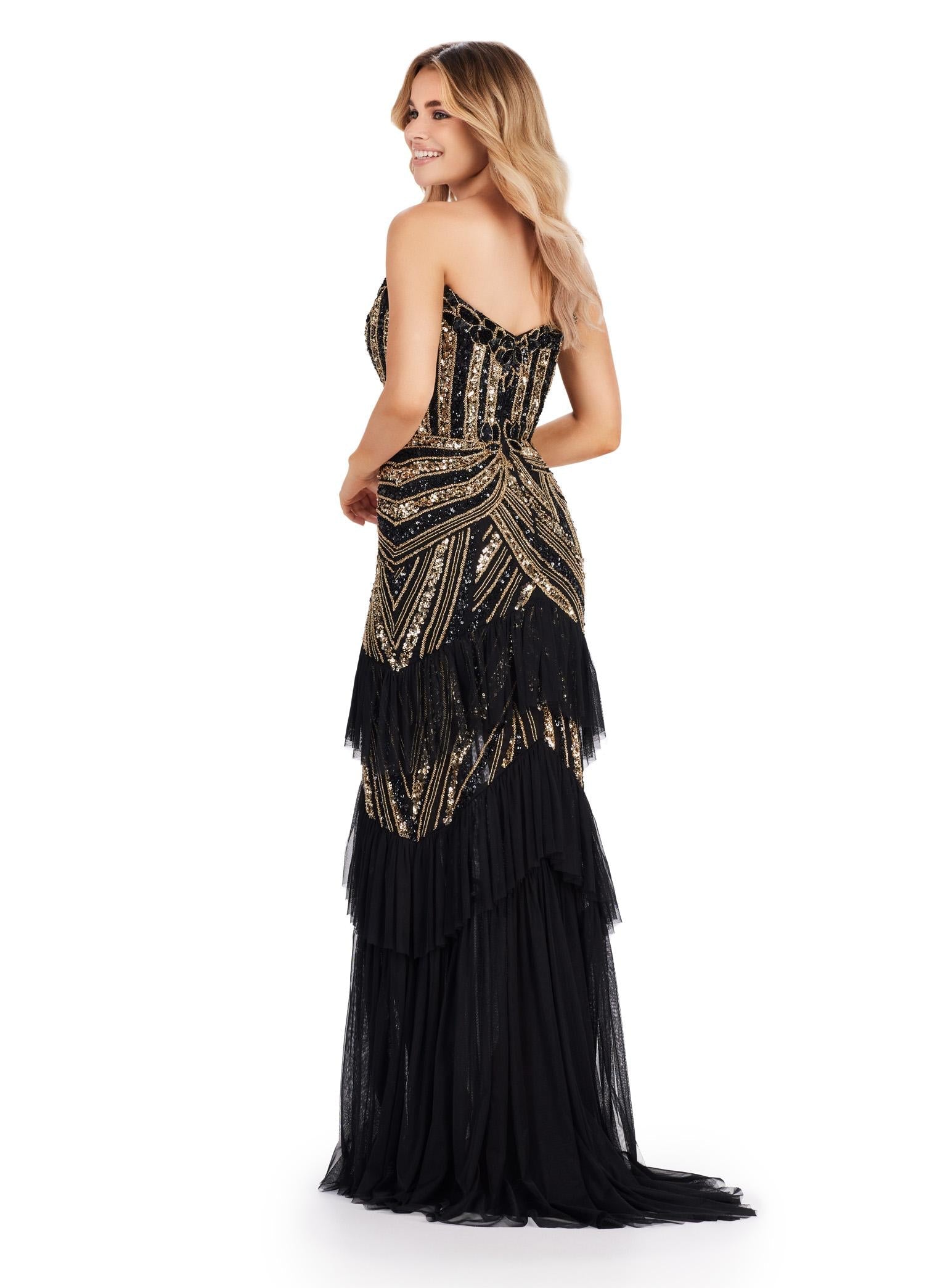 Back. Black/Gold ASHLEYlauren 11438 glamorous gown featuring a sweetheart illusion V-neckline, ornate bead pattern, striking V-back, tiered ruffle skirt, and a center slit with tulle details for an elegant and dramatic look.