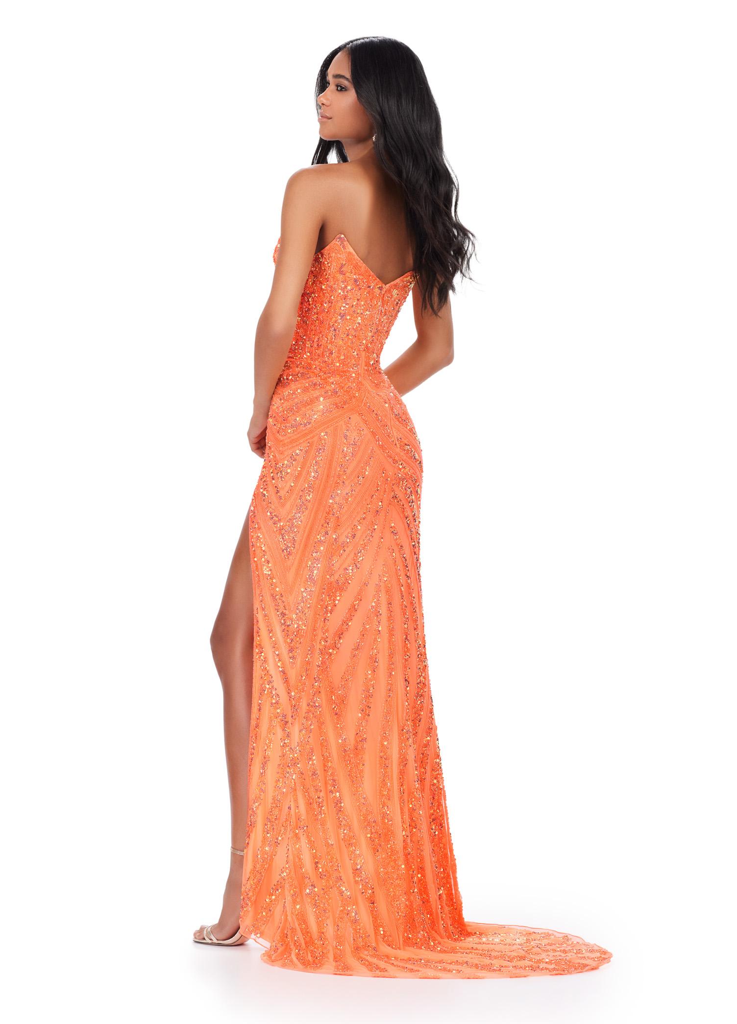 Back. Coral ASHLEYlauren 11236 strapless gown featuring a sweetheart neckline, modern floral sequin motif cascading down the bustier and skirt, and a left leg slit for a glamorous and head-turning look.