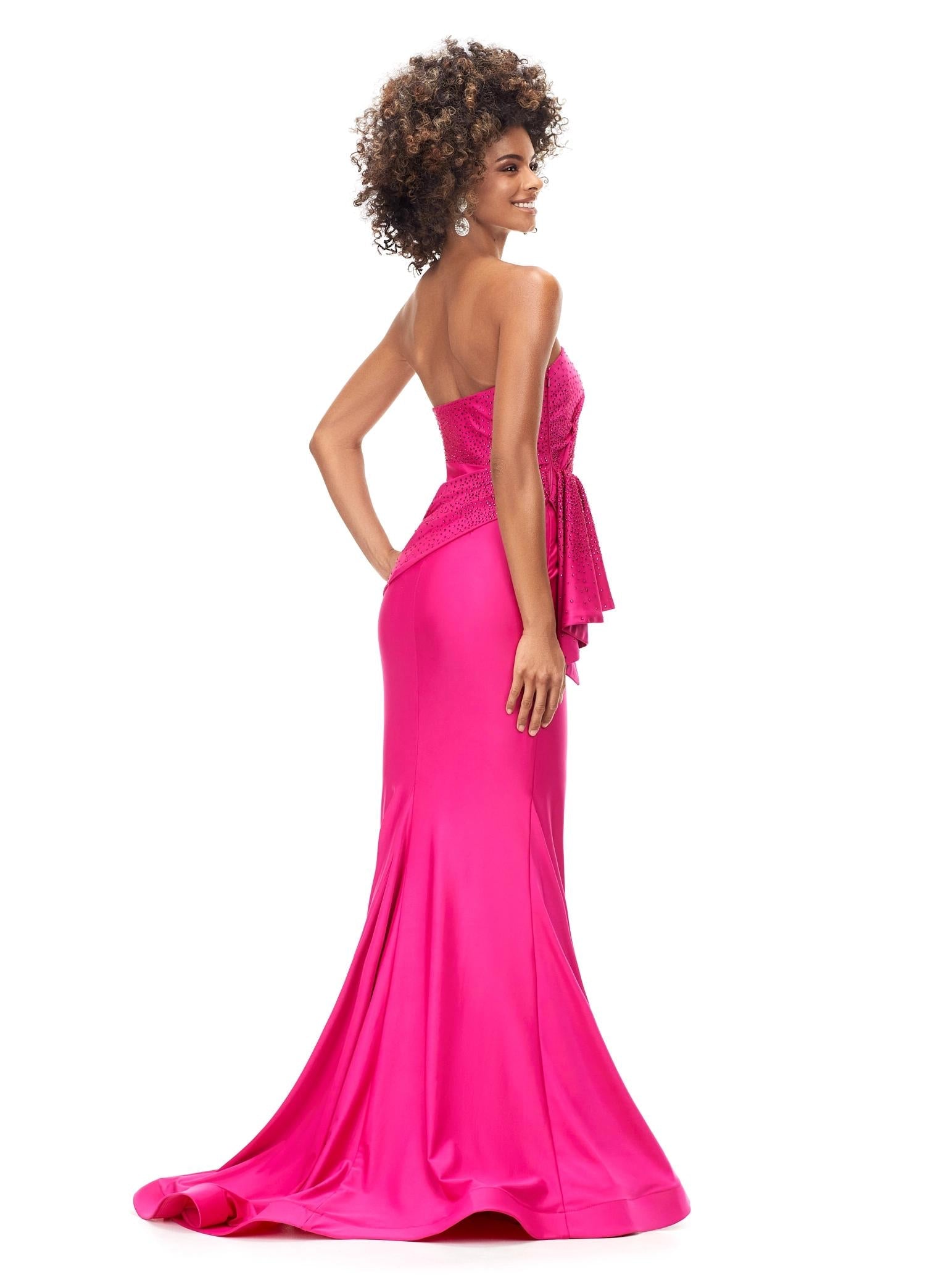 Back. Fuchsia ASHLEYlauren 11295 strapless jersey gown featuring a wrap bustier adorned with press-on stones, a knot detail at the waist, and a sweep train for a sleek and elegant silhouette.