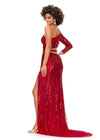 Back. Red ASHLEYlauren 11261 fully hand-beaded one shoulder gown featuring a shark bite cut out at the waist, left leg slit, and intricately placed bead pattern to accentuate curves, complete with scattered fringe along the shoulder and waistline for a bold and glamorous look.