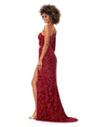 Back. Red ASHLEYlauren 11340 sequin one shoulder gown featuring a single sleeve, shark bite cut-out, wrap skirt, and left leg slit for a striking and glamorous look.