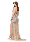 Back. Silver ASHLEYlauren 11261 fully hand-beaded one shoulder gown featuring a shark bite cut out at the waist, left leg slit, and intricately placed bead pattern to accentuate curves, complete with scattered fringe along the shoulder and waistline for a bold and glamorous look.