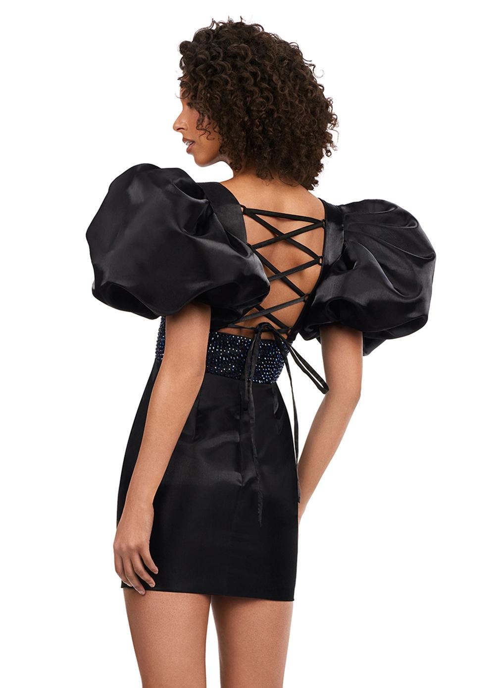 Back - Black ASHLEYlauren 4549 cocktail dress featuring a V-neckline, oversized puff sleeves, heat set stone-embellished waistband, fitted skirt, and center lace-up back for a bold and glamorous look.