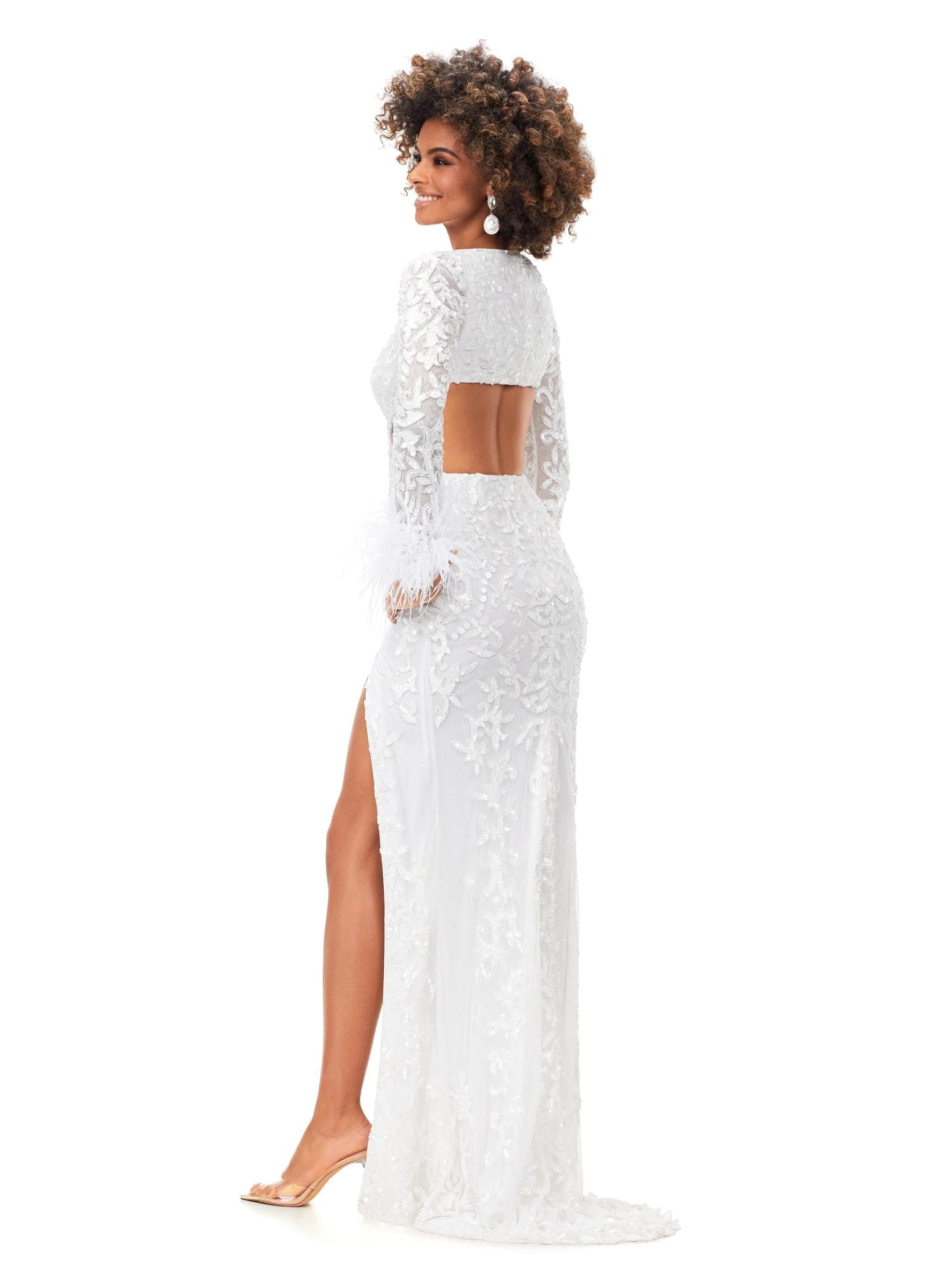 Back - Ivory ASHLEYlauren 11364 beaded gown featuring a V-neckline, crisscross cut-out bodice, long sleeves trimmed with feathers, left leg slit, and a sweep train for added drama.