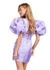 Back - Orchid ASHLEYlauren 4549 
cocktail dress featuring a V-neckline, oversized puff sleeves, heat set stone-embellished waistband, fitted skirt, and center lace-up back for a bold and glamorous look.