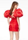 Back - Red ASHLEYlauren 4549 cocktail dress featuring a V-neckline, oversized puff sleeves, heat set stone-embellished waistband, fitted skirt, and center lace-up back for a bold and glamorous look.