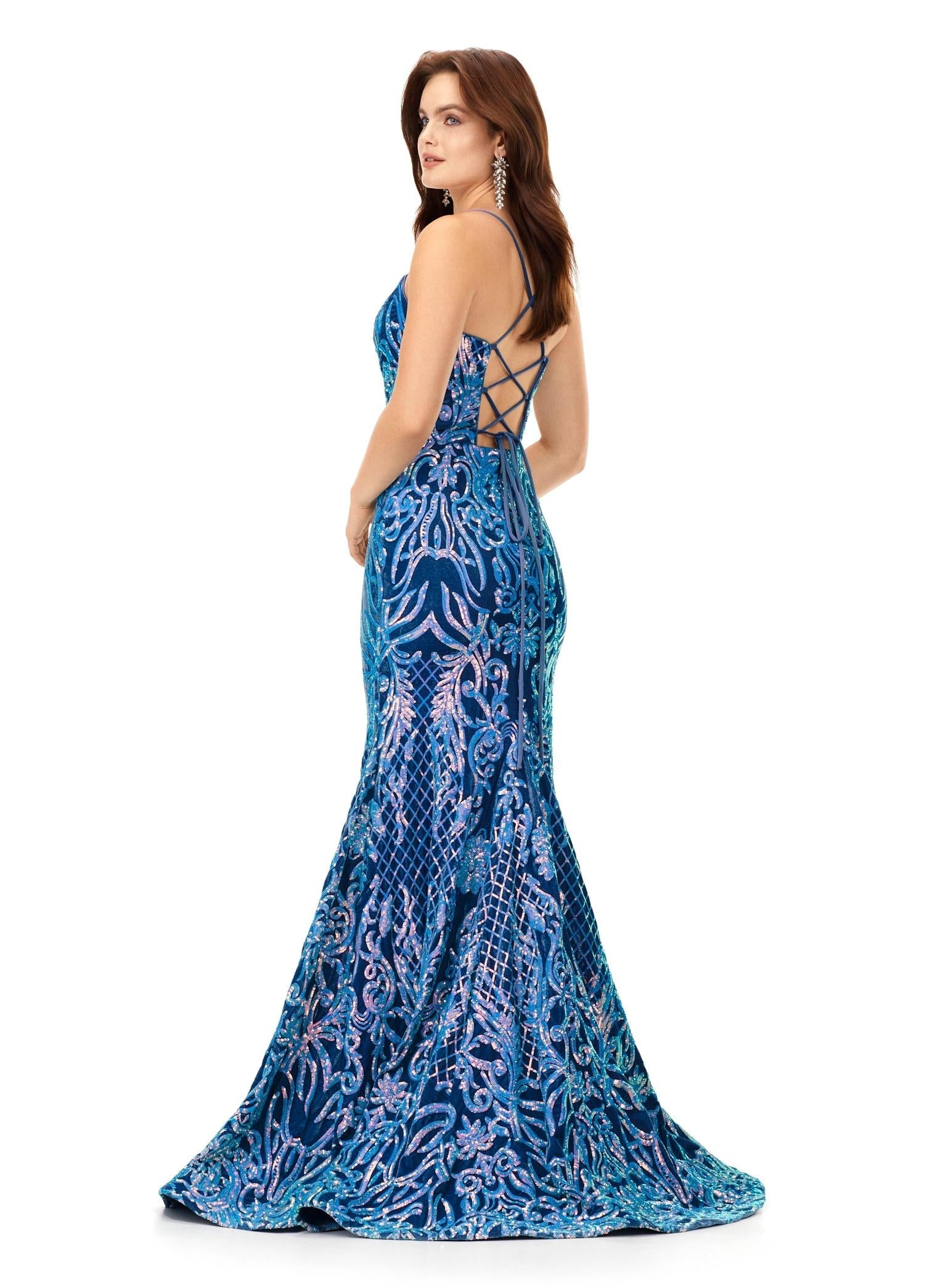 Back view. Turquoise/Royal ASHLEYlauren 11331 stunning velvet sequin gown featuring delicate spaghetti straps, a lace-up back for a perfect fit, intricately placed sequin appliques to complement your curves, and a sweep train for a glamorous and show-stopping entrance.