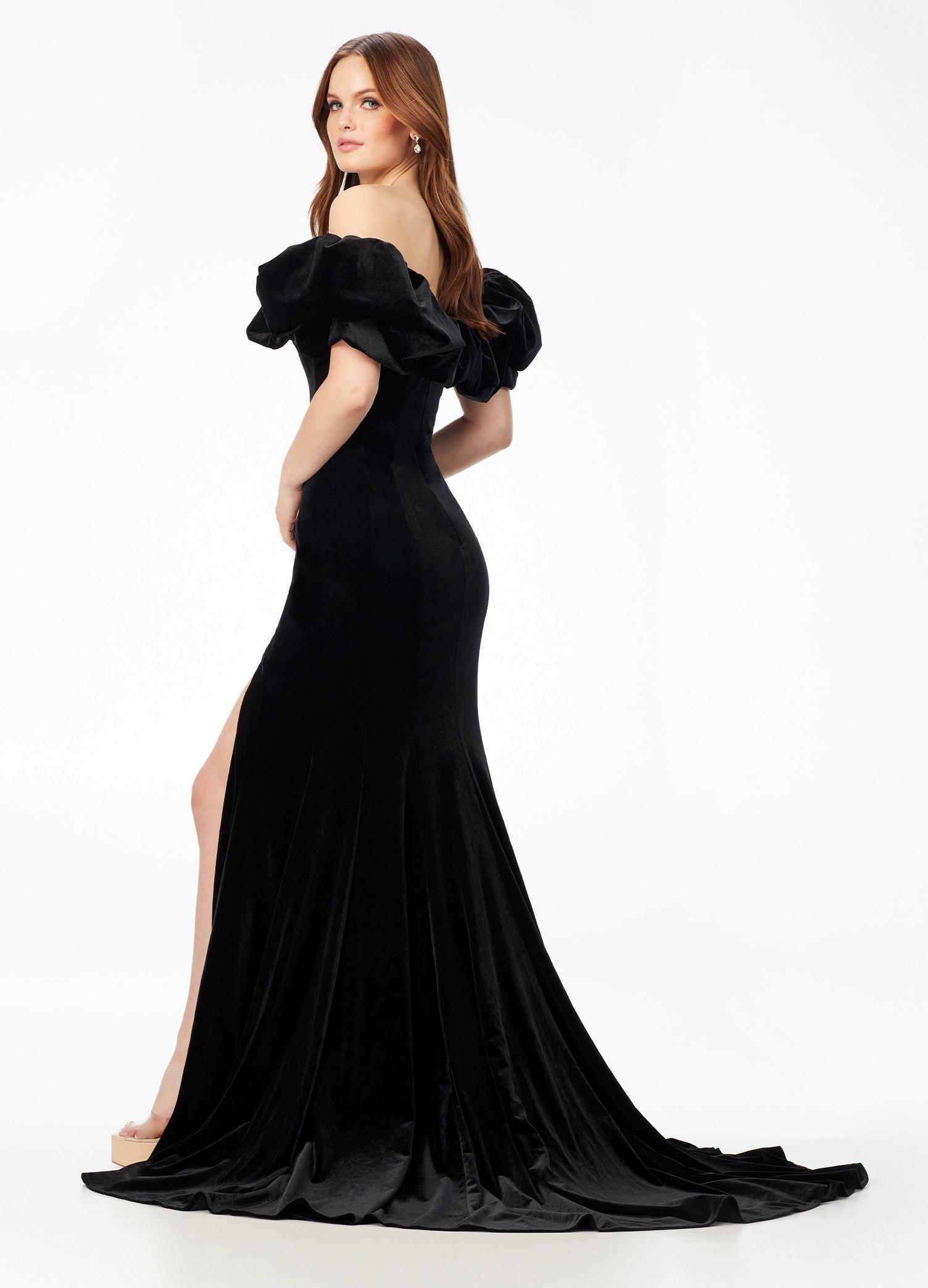 Back - Black ASHLEYlauren 11217 – A magnificent off-shoulder velvet gown featuring oversized ruffle details, a contour seamed skirt with a left leg slit, and a dramatic train. Perfect for making a bold, elegant statement at any event.