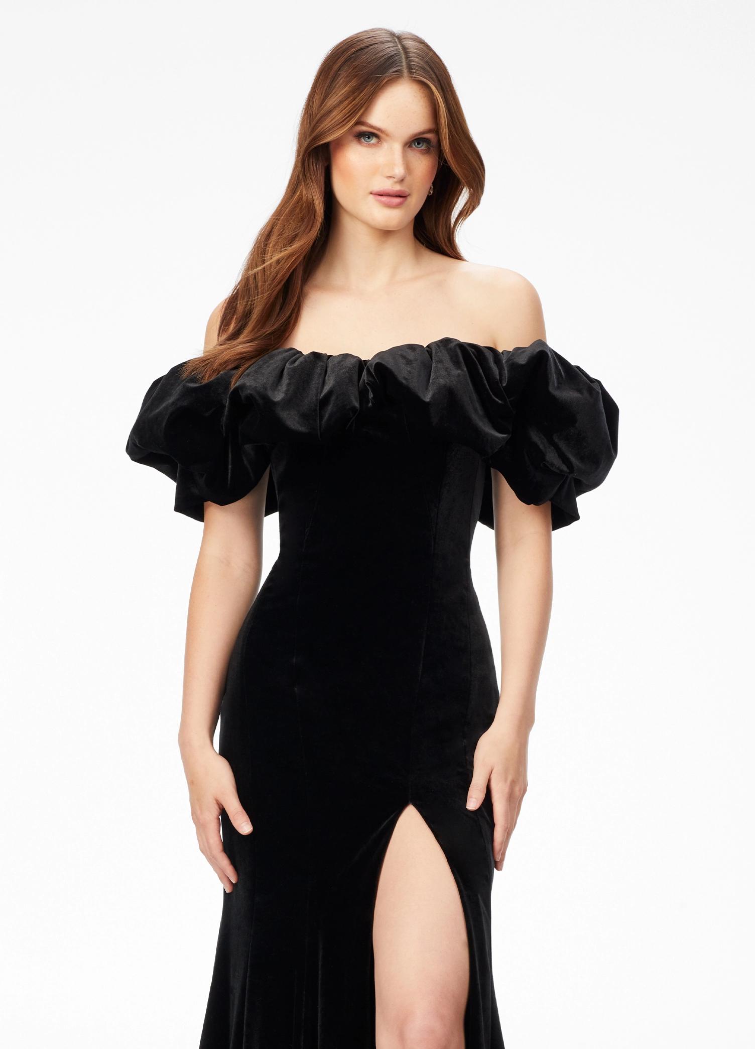 Black ASHLEYlauren 11217 – A magnificent off-shoulder velvet gown featuring oversized ruffle details, a contour seamed skirt with a left leg slit, and a dramatic train. Perfect for making a bold, elegant statement at any event.