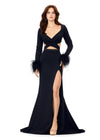 Black ASHLEYlauren 11308 striking scuba gown featuring a deep V-neckline, criss-cross cut out bodice, crystal waistline, long sleeves adorned with heat-set stones and feather trim, a fitted skirt, and a left leg slit for a bold and glamorous statement look.