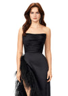 Black ASHLEYlauren 11313 strapless satin gown featuring a ruched bustier, slight A-line skirt, high right leg slit, and cascading feather trim along the hemline.