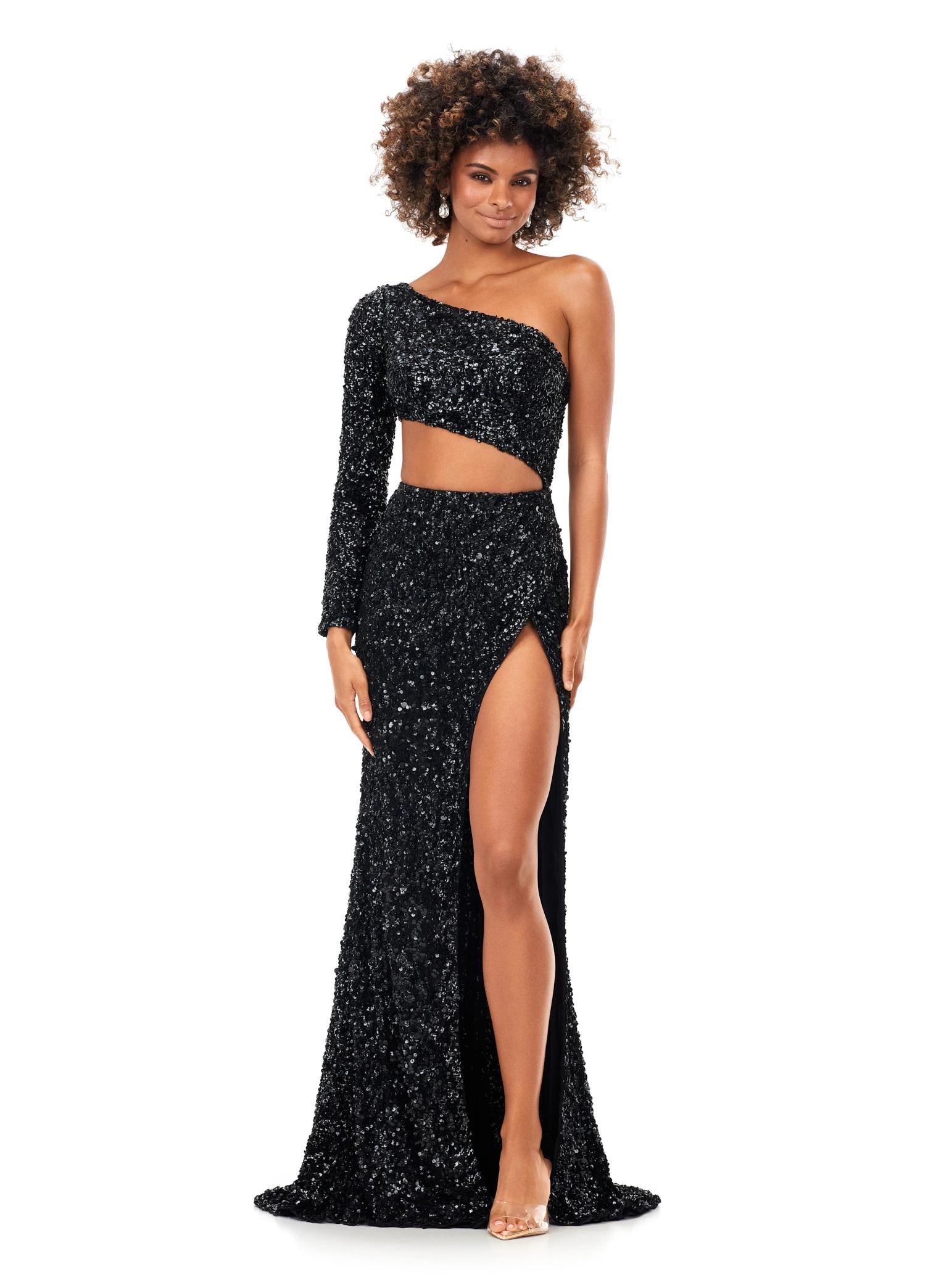Black ASHLEYlauren 11340 sequin one shoulder gown featuring a single sleeve, shark bite cut-out, wrap skirt, and left leg slit for a striking and glamorous look.