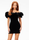 Black ASHLEYlauren 4528 off shoulder stretch velvet cocktail dress featuring an oversized ruffle detail and contoured seaming throughout the fitted skirt for a chic, curve-enhancing look.