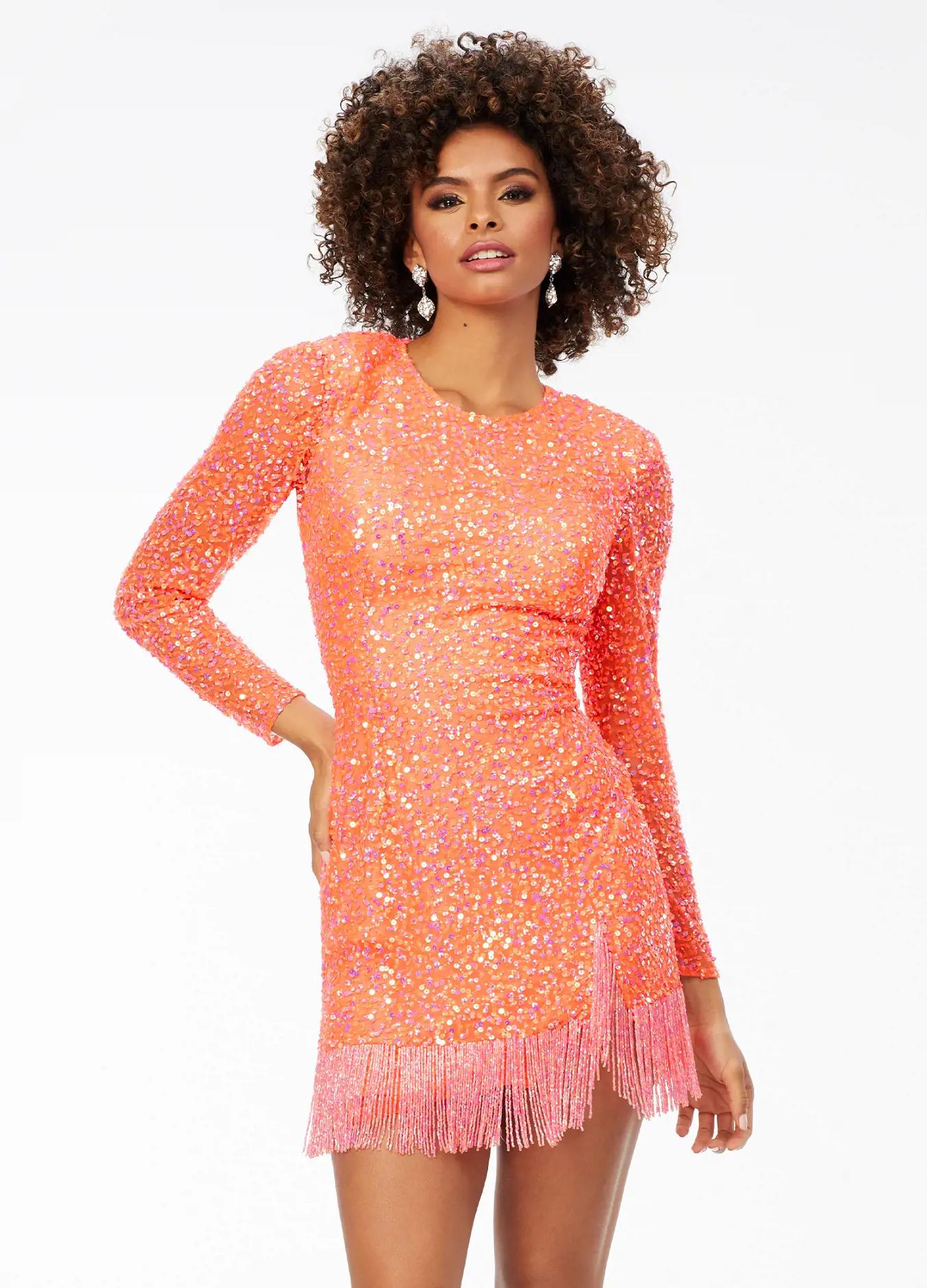ASHLEYlauren 4438 – A sassy and classy fully hand-beaded long sleeve cocktail dress featuring a fitted skirt with fringe detail along the left leg slit and hemline. Perfect for making a bold, elegant statement at any event.