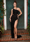 Editorial. Black ASHLEYlauren 11280 daring one shoulder gown featuring an intricate bead pattern, scattered fringe accents, bold side cut outs, and a left leg slit for a striking and glamorous statement look.