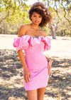 Editorial - Pink ASHLEYlauren 4528 off shoulder stretch velvet cocktail dress featuring an oversized ruffle detail and contoured seaming throughout the fitted skirt for a chic, curve-enhancing look.
