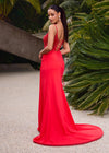 Editorial Back. Red ASHLEYlauren 11664 fitted jersey gown featuring a fully beaded corset bustier, spaghetti straps, lace-up back, ruched waist detailing, and a left leg slit for a sleek and glamorous look.