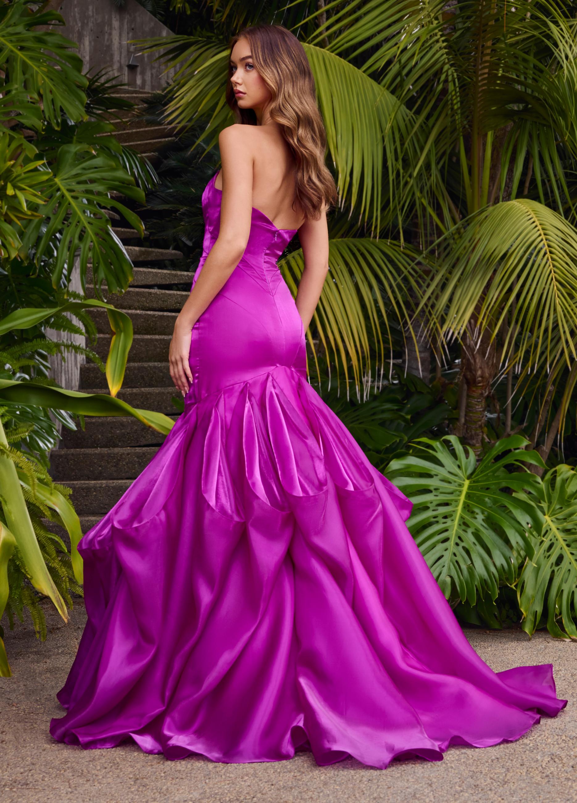 Editorial back. Purple ASHLEYlauren 11733 glamorous strapless gown featuring a sweetheart neckline, shiny organza fabric, fit and flare silhouette, and a dramatic ruffle mermaid skirt for an elegant and show-stopping look.