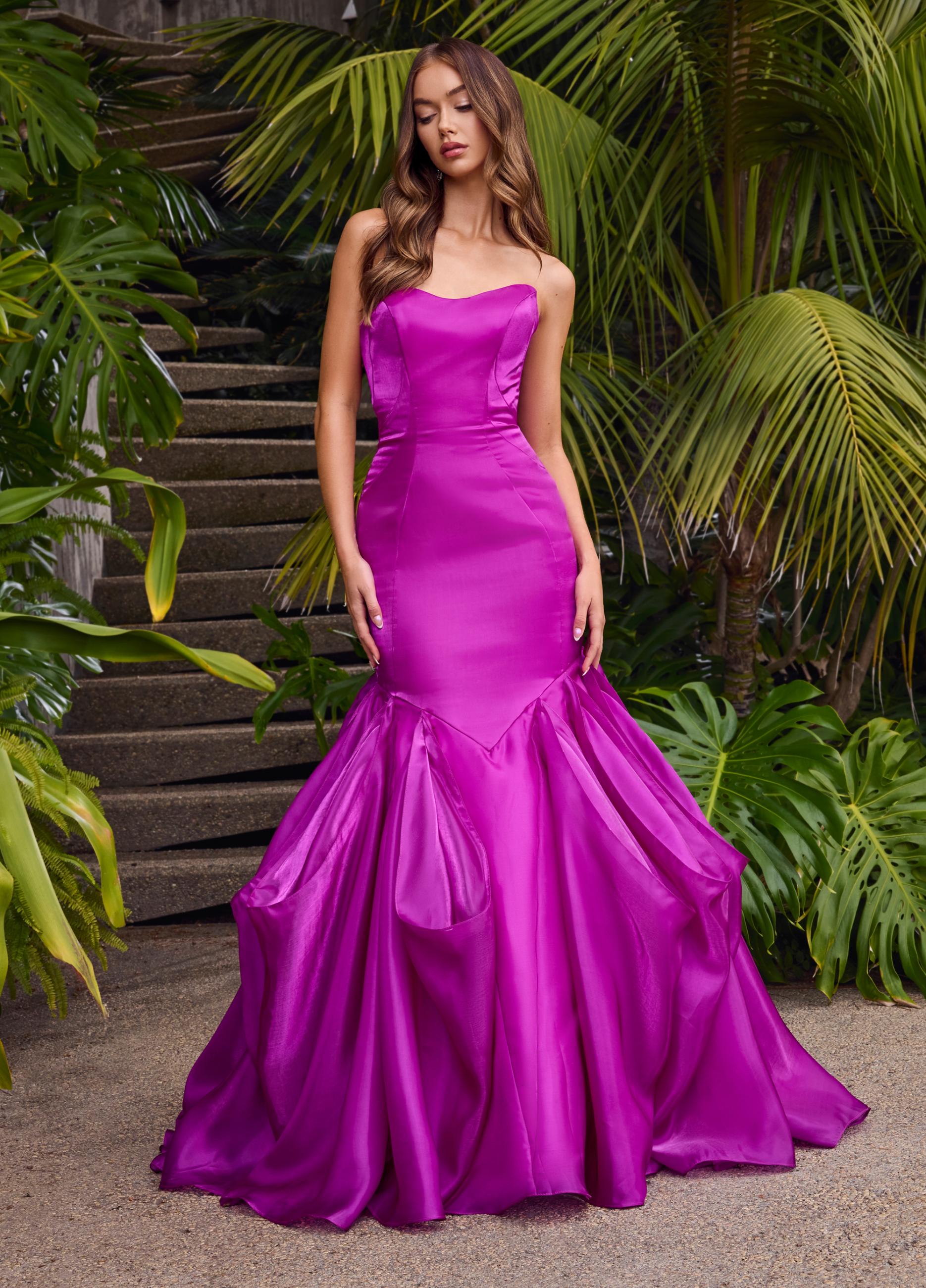 Editorial front. Purple ASHLEYlauren 11733 glamorous strapless gown featuring a sweetheart neckline, shiny organza fabric, fit and flare silhouette, and a dramatic ruffle mermaid skirt for an elegant and show-stopping look.