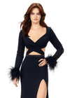 Front view. Black ASHLEYlauren 11308 striking scuba gown featuring a deep V-neckline, criss-cross cut out bodice, crystal waistline, long sleeves adorned with heat-set stones and feather trim, a fitted skirt, and a left leg slit for a bold and glamorous statement look.