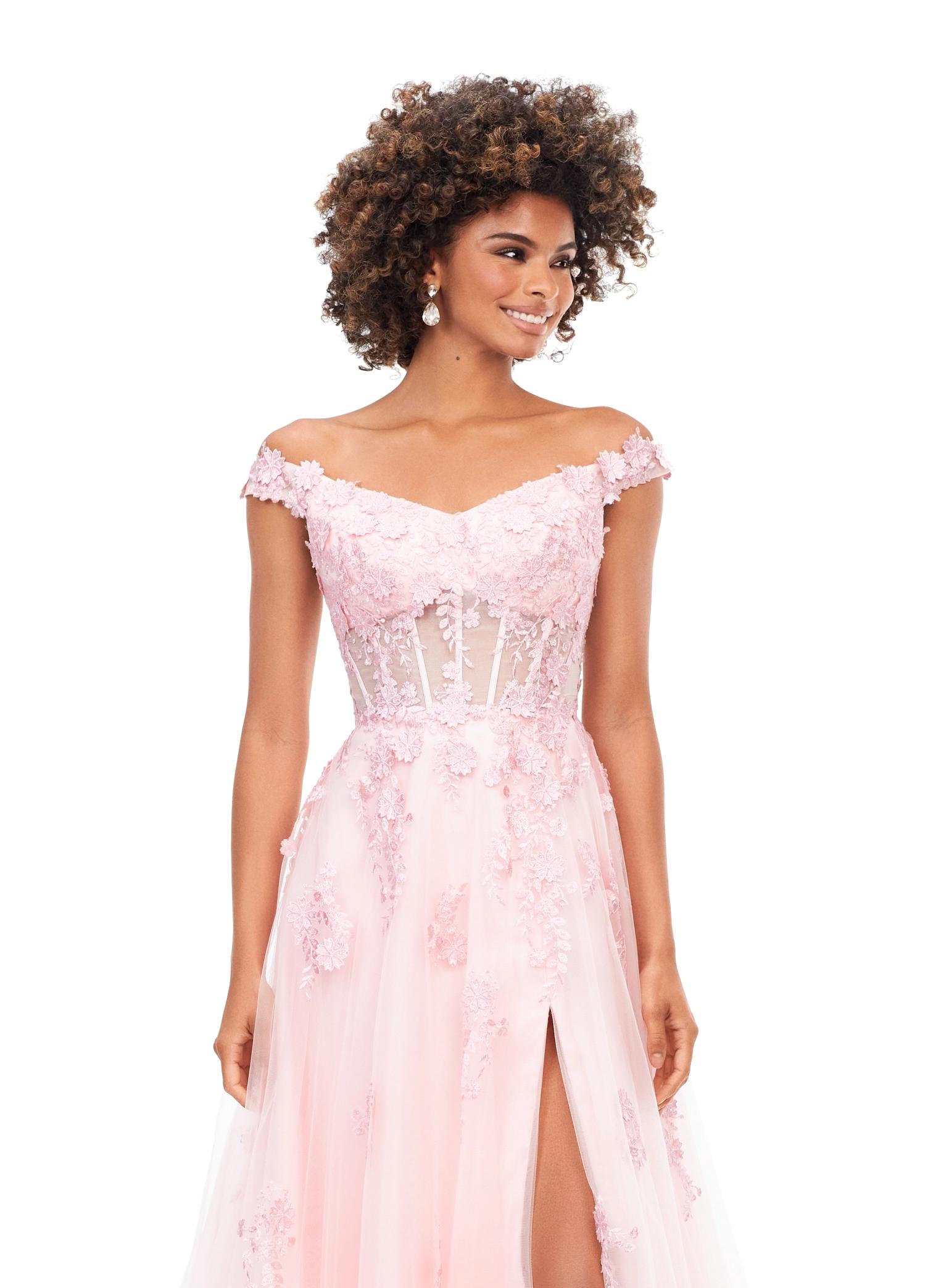 Front view. Pink ASHLEYlauren 11376 fairytale-inspired off-shoulder gown featuring an illusion corset bodice, delicate 3D lace flower appliques cascading throughout layers of tulle, and a left leg slit for an ethereal and romantic look.