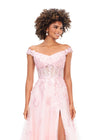 Front view. Pink ASHLEYlauren 11376 fairytale-inspired off-shoulder gown featuring an illusion corset bodice, delicate 3D lace flower appliques cascading throughout layers of tulle, and a left leg slit for an ethereal and romantic look.