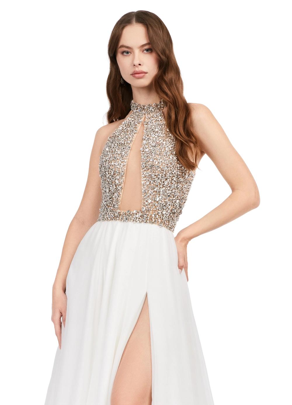 Ivory ASHLEYlauren 11248 – A stunning chiffon A-line gown featuring a beaded halter top with crystal details, an illusion cut-out, and a high left leg slit. Perfect for shining bright and making a statement at any special event.