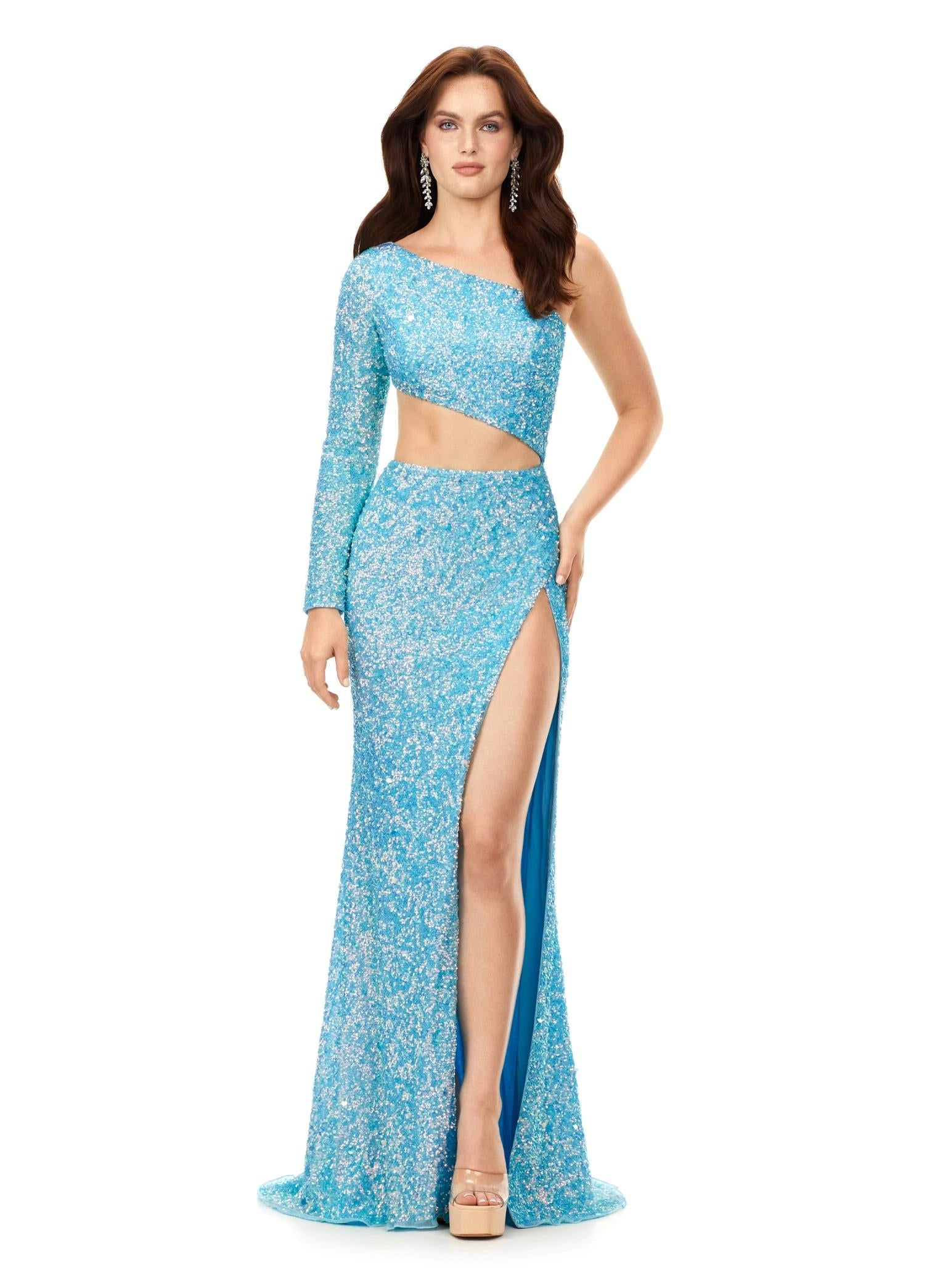 Light Blue ASHLEYlauren 11340 sequin one shoulder gown featuring a single sleeve, shark bite cut-out, wrap skirt, and left leg slit for a striking and glamorous look.