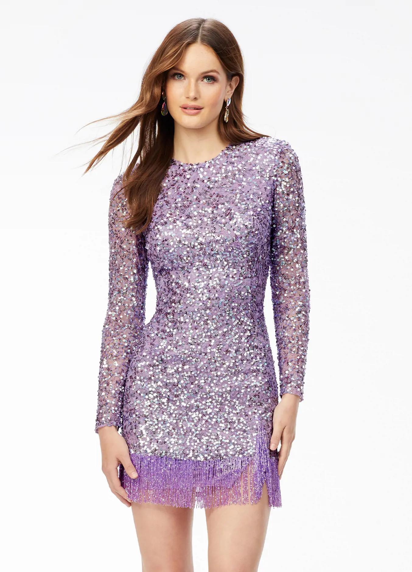 ASHLEYlauren 4438 – A sassy and classy fully hand-beaded long sleeve cocktail dress featuring a fitted skirt with fringe detail along the left leg slit and hemline. Perfect for making a bold, elegant statement at any event.