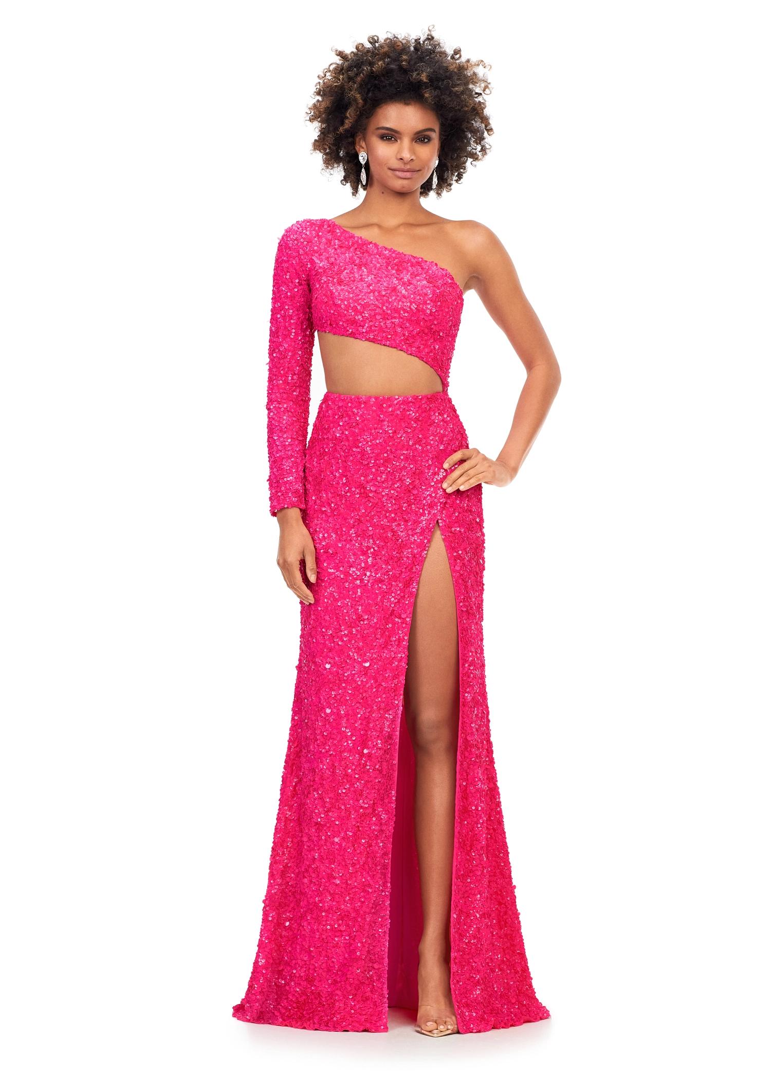 Pink ASHLEYlauren 11340 sequin one shoulder gown featuring a single sleeve, shark bite cut-out, wrap skirt, and left leg slit for a striking and glamorous look.