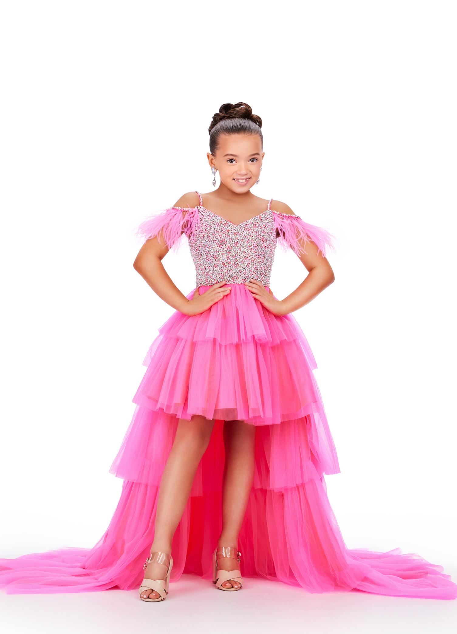 Pink ASHLEYlauren 8259 fun and flirty kids high-low tulle dress featuring a V-neckline, V-back, off shoulder feather straps, and a crystal-encrusted beaded bustier for a dazzling and stylish look.