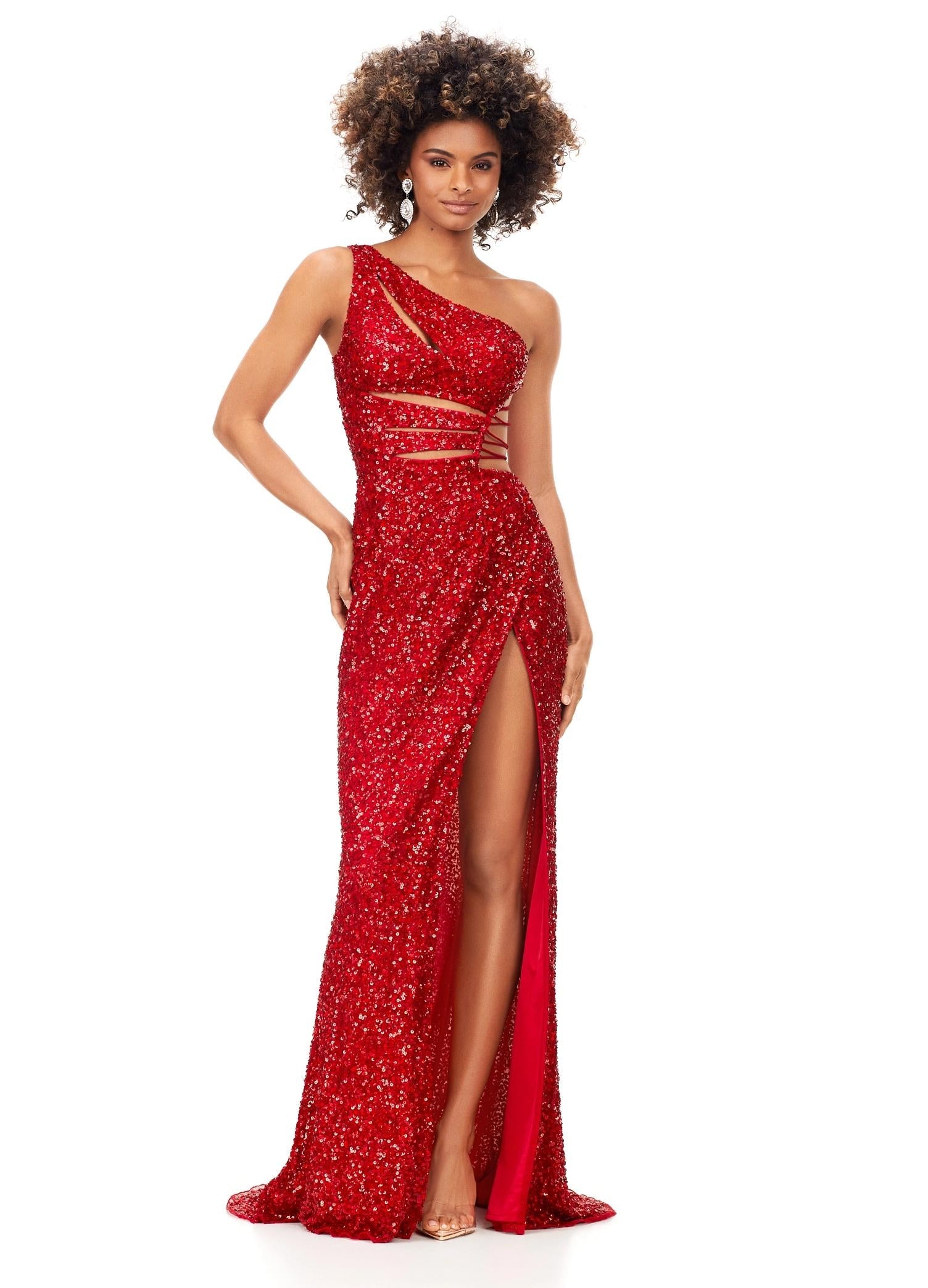 Red ASHLEYlauren 11288 stunning one shoulder fully hand-beaded gown featuring modern cut outs, criss cross waist straps, a left leg slit, and a sweep train for a bold and statement-making entrance.