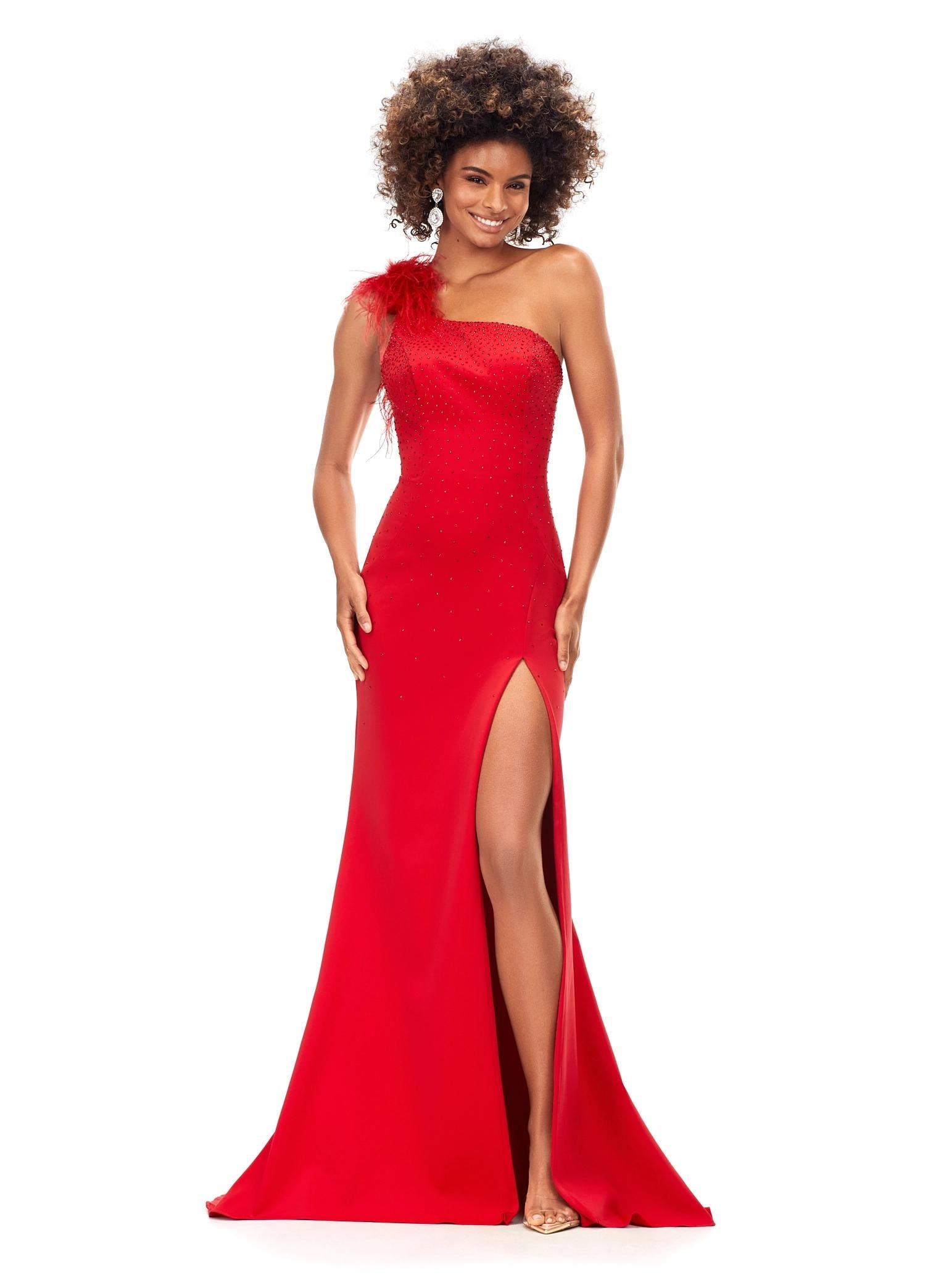 Red ASHLEYlauren 1129 one shoulder scuba gown featuring feather-embellished neckline, heat set stones cascading down the skirt, and a left leg slit for a bold and elegant look.