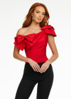 Red ASHLEYlauren 9001 elegant one shoulder bustier featuring asymmetrical ruching and delicate bow accents, perfect for styling with jeans or for pageant headshots.